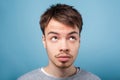 What`s with my hair. Closeup portrait of young brunette man looking up with inquiring gaze, dissatisfied with messy fringe Royalty Free Stock Photo