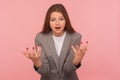 What`s the problem? Portrait of irritated indignant young woman in business suit raising hands in anger