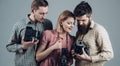 What a shot. Photography studio. Retro style woman and men hold analog photo cameras. Paparazzi or photojournalists with