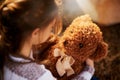 What should we do next, teddy. Rearview shot of an unidentifiable little girl holding her teddy bear while playing Royalty Free Stock Photo