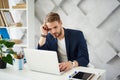 Thoughtful male working in business center