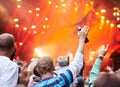 What a show. Rearview shot of a crowd of fans cheering at an outdoor music event.