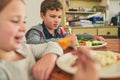 What is this stuff, anyway. two grumpy children refusing to eat their vegetables. Royalty Free Stock Photo