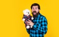 What a surprise. happy man holding teddy bear. cheerful man in checkered shirt with bear toy. feel of happiness and joy Royalty Free Stock Photo