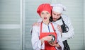 What a surprise for them. Family cooking in kitchen. secret ingredient by recipe. cook uniform. couple in love with Royalty Free Stock Photo