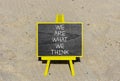 We are what we think symbol. Concept word We are what we think on beautiful black chalkboard. Beautiful sea sand beach background