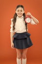 What time is it. time to go to school. Children education. Knowledge day. Happy girl hold alarm clock counting for lunch Royalty Free Stock Photo