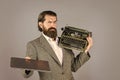 What to choose. mature man hold vintage device. first draft. professional typist make notes. modern and old technology Royalty Free Stock Photo