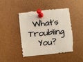 What is troubling you text on white notepad. Royalty Free Stock Photo