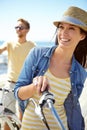 What a view. A happy young couple riding their bicycles on the promenade on a summers day. Royalty Free Stock Photo