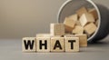 What - word concept from wooden blocks on desk