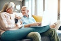 What would you like me to browse for. mature couple using a laptop on the sofa at home. Royalty Free Stock Photo