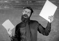What would you prefer. Teacher bearded hipster holds book and laptop. Teacher choosing modern teaching approach. Digital