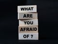 What are you afraid of, quote text written on wooden block, motivation inspiration