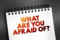 What Are You Afraid Of? text on notepad, concept background