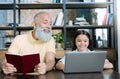 Curious granddad looking at laptop of granddaughter with interest Royalty Free Stock Photo