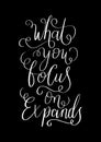 Hand Lettered What You Focus On Expands On Black Background Royalty Free Stock Photo