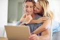 What you looking at. a happy mature couple using a laptop at home. Royalty Free Stock Photo