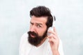 What are you saying. its too loud. Put your headset on. bearded man wear headphones. brutal hipster listen to music Royalty Free Stock Photo