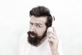 What are you saying. its too loud. Put your headset on. bearded man wear headphones. brutal hipster listen to music Royalty Free Stock Photo