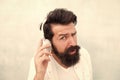 what are you saying. its too loud. Put your headset on. bearded man wear headphones. brutal hipster listen to music Royalty Free Stock Photo