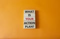 What is your action plan symbol. Wooden blocks with words What is your action plan. Beautiful orange background. Business and What Royalty Free Stock Photo