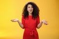 What your problem. Annoyed and confused pissed girlfriend with curly hair in elegant party dress shrugging with hands Royalty Free Stock Photo