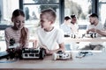 Adorable youngsters talking over new robotic machine