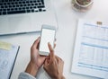 Whatever business info you need the internet has it. a businesswoman using a mobile phone at her desk in an office. Royalty Free Stock Photo