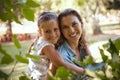 Whatever you do, make it fun. an adorable little girl enjoying a piggyback ride with her mother in the park. Royalty Free Stock Photo