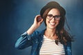 Whatever your style, always smile. Studio portrait of an attractive young woman smiling against a blue background.