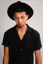 Whats that on the ground. Cropped studio shot of a handsome young man wearing a hat and contemplating while standing Royalty Free Stock Photo