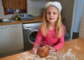 Whats next after the eggs. a little girl baking in the kitchen. Royalty Free Stock Photo