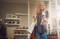 Whats next on the Hottest clothing stores list. a young woman using her cellphone while out shopping. Royalty Free Stock Photo