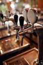 Whats on tap today. Closeup of a couple of beer taps standing and waiting to be used inside of a beer brewery during the Royalty Free Stock Photo