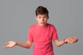 Whats your problem. teenager boy in casual pink t shirt, spread hands sideways complaining, having argument, look confused