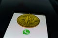 WhatsApp application on smartphone and bitcoin cryptocurency. WhatsApp launches cryptocurrency payments