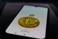 WhatsApp application on smartphone and bitcoin cryptocurency. WhatsApp launches cryptocurrency payments