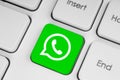 WhatsApp icon key on white computer keyboard close-up. Concept of working process in popular social media services. WhatsApp