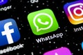 Whatsapp messenger application icon on Apple iPhone X smartphone screen close-up. Whatsapp messenger app icon. Social media icon. Royalty Free Stock Photo