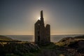 Wheal Owles tin mine, Cornwall, illuminated from behind by the setting sun Royalty Free Stock Photo
