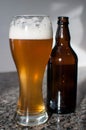 Wheat beer glass and brown bottle