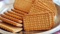 Wheat biscuits in the steel plate with blury background. Indian biscuits popularly known as Chai-biscuit in India