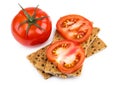 Wheat crisp bread and tomato isolated on white Royalty Free Stock Photo