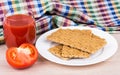 Wheat crisp bread, tomato and juice on table Royalty Free Stock Photo