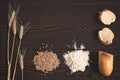 Wheat ears, grains, flour and sliced bread on a dark wooden table Royalty Free Stock Photo