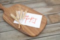 Wheat ears and a note advocating conservation are on the cutting board Royalty Free Stock Photo