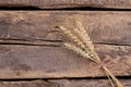 Wheat ears on old wooden background. Royalty Free Stock Photo