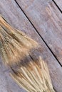 Wheat ears on wooden background, top view.