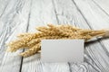 Wheat Ears on Wooden Table with blank business cards. Sheaf of Wheat over Wood Background. Harvest concept. Royalty Free Stock Photo
